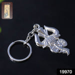 Close-up of intricate silver Trishul and Damru details on keychain