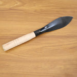 Heavy duty gardening trowel in garden setting used for planting