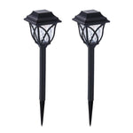 FitFuzion solar pathway lights casting bright, artistic patterns on a dark garden path, enhancing outdoor decor.