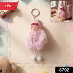 Close-up view of plush doll and fluffy fur ball keychain showing soft texture