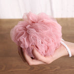 Ergonomic back scrubber with a soft loofah sponge for easy use.