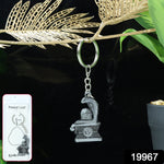 Detailed close-up of silver metal Shivling keychain with snake