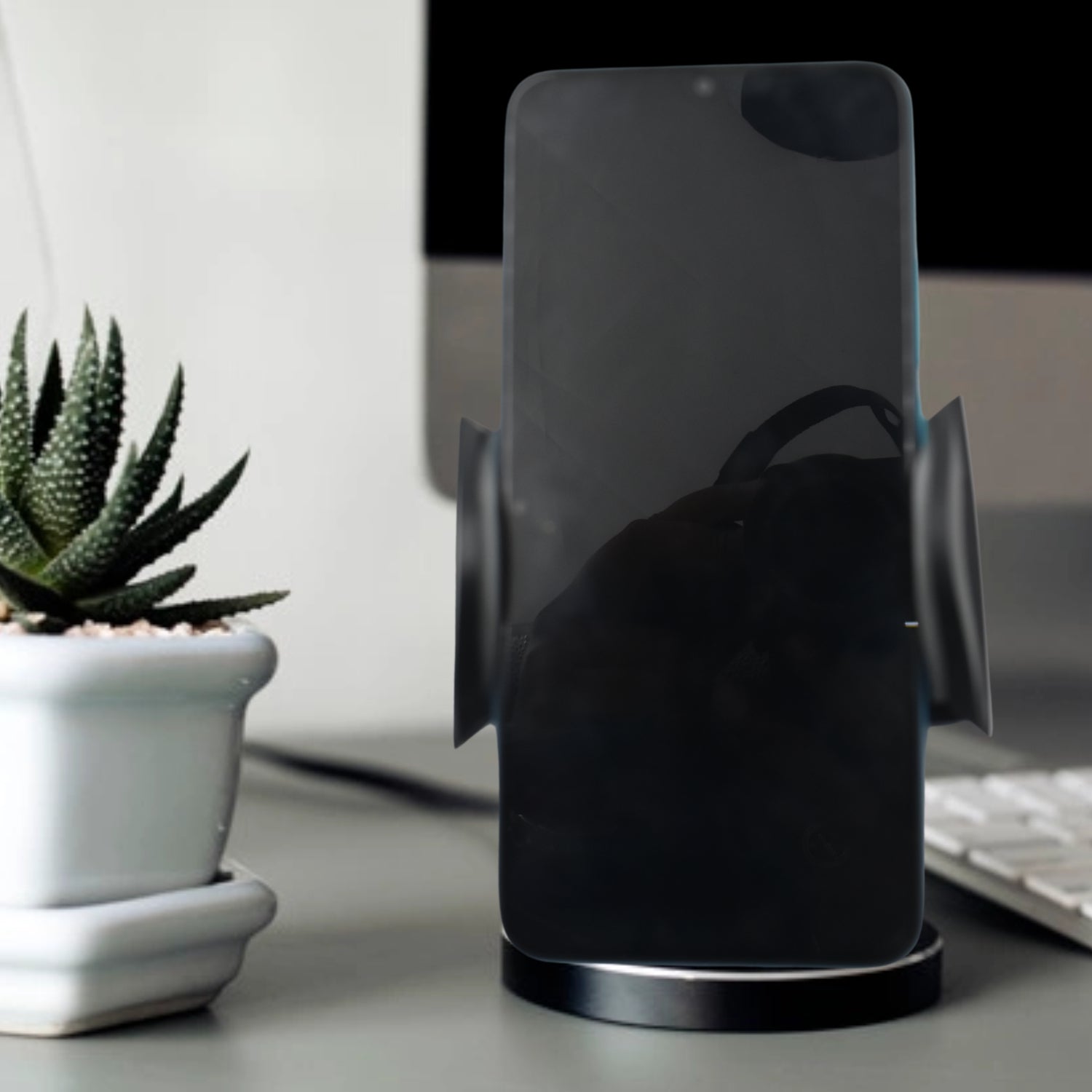 A smartphone securely mounted in the PHOBIA Car Vent Mobile Holder inside a car.