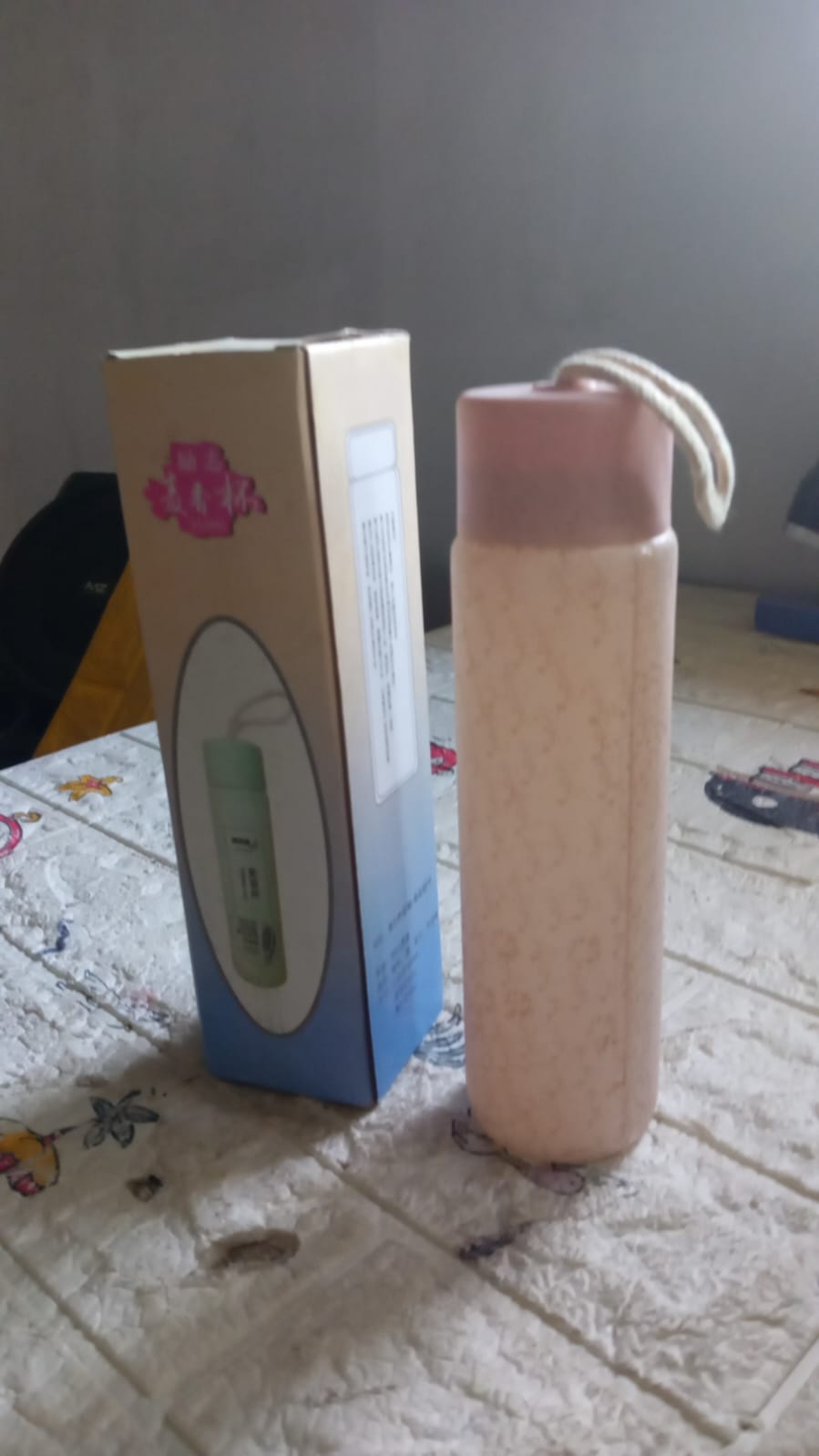 Hand holding the compact 350ml glass water bottle, ready for travel or daily use.
