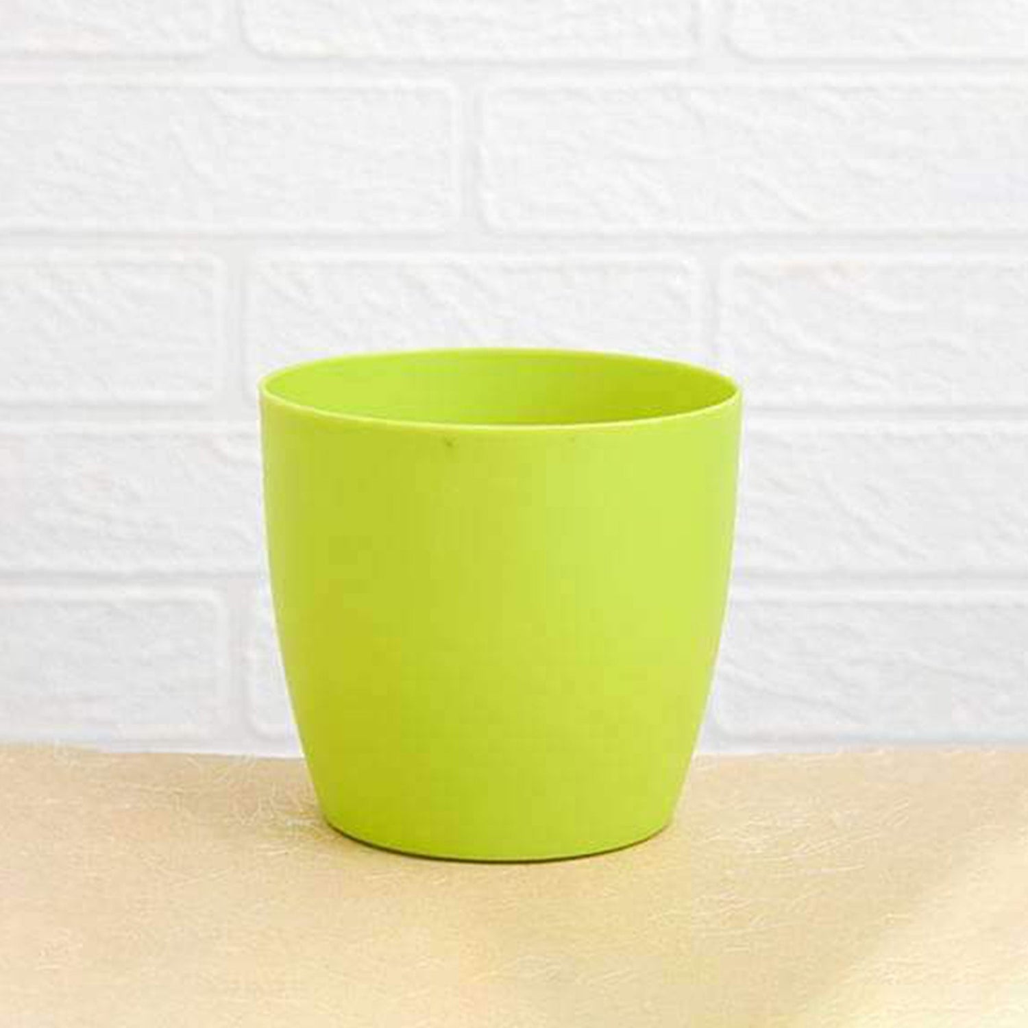 Round plastic flower pots displayed in a garden setting, suitable for all weather.