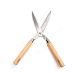Indo Glow Hedge Shears resting on green foliage, ready for efficient garden maintenance.