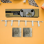 The utensil hanger rail mounted on a kitchen wall, neatly holding various kitchen ladles and tools.