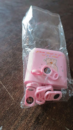 A hand holding the compact and portable GiftingGrace birthday projector.