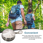 Stainless steel folding camping cup laid out with outdoor equipment.
