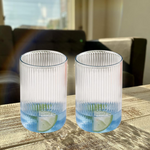 Full set of six Supermom plastic ribbed tall glasses on table
