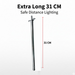 Stainless steel gas lighter igniting a kitchen stove burner.