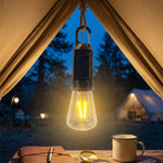 Solar camping lamp illuminating outdoor tent