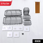 Black metal shower caddy hanging on shower arm holding bathroom essentials