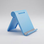 Foldable mobile phone stand in packing box.