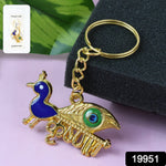 Close-up detail of the golden Krishna Peacock keychain's artistic motif