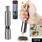 Hand operating a sleek thumb press grinder for fresh pepper.