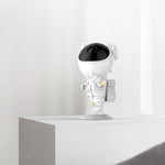 Side view of the astronaut night light lamp projecting a calming starry ambiance.