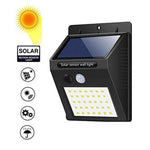 Sleek black solar LED night light illuminating a home's outdoor area.
