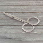 Elegant compact nail clipper set with its clear storage case for easy access.