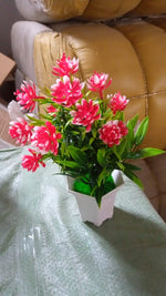 An artificial flower plant in a stylish pot, ready to enhance your home office decor.