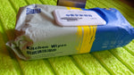 Velvet Wipe cleaning a greasy kitchen cooktop, demonstrating effective grime removal.