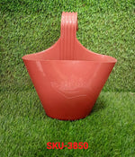 Single hanging planter pot on a balcony railing.