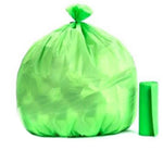 Opened roll of green eco-friendly garbage bags (19x21 inches) for home waste.