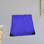 Close-up of the high-density fabric of the compact reusable shopping bag.