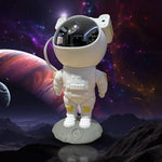 Astronaut galaxy projector with remote control on a wooden surface, ready to use.