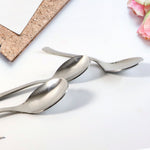 Set of three rust-resistant dining spoons neatly arranged