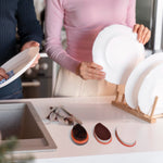 Ergonomic wet and dry brush vigorously cleaning a kitchen counter surface.
