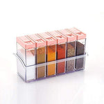 Close-up of multicolor plastic spice jars with their vibrant lids.