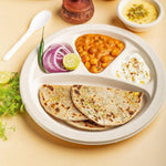 Disposable 4 compartment meal serving plate holding snacks and main course