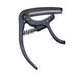 Wagtail guitar capo securely clamped on an acoustic guitar neck.