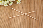 Bundle of natural bamboo skewers tied with string for display.