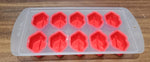 Assorted colorful silicone ice cube moulds featuring various fruit designs for creative desserts.