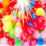 Kids having fun throwing quick-fill Holi water balloons during celebrations.