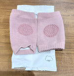 Close-up of knitted pink wool toddler knee warmers with protection