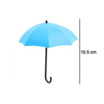 Decorative umbrella-shaped adhesive wall hook displayed against a cheerful, colorful background.