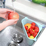 Triangular sink drainer shelf organizing kitchen essentials in a home.