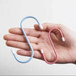 Multiple S hooks on a standard rod, demonstrating their easy application for various items.