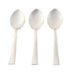 Three stainless steel dining spoons arranged side by side for tableware