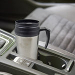 Enjoying hot coffee in a portable stainless steel travel mug.