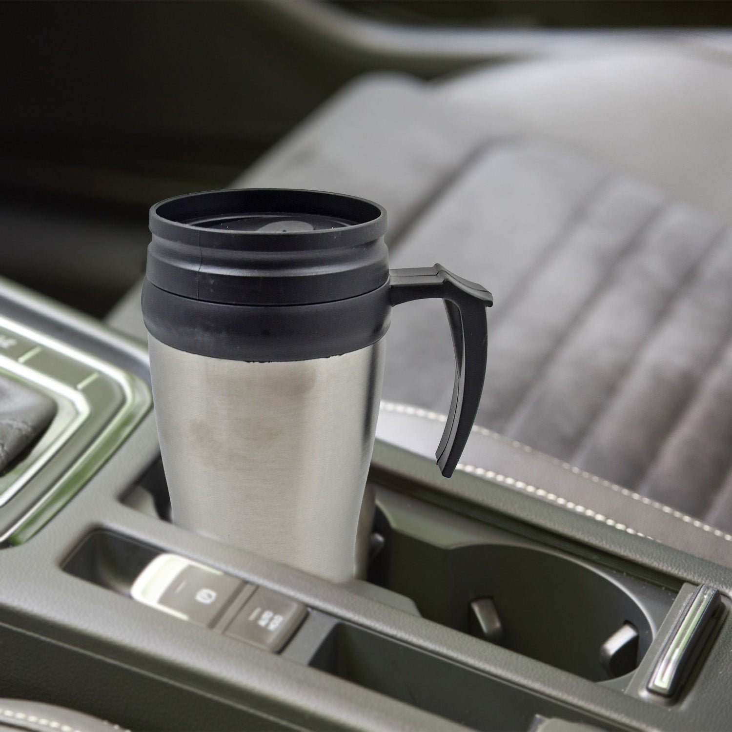 Enjoying hot coffee in a portable stainless steel travel mug.