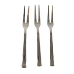 Three small appetizer forks laid out for serving snacks