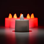 Red flameless tealight candles placed in decorative holders creating ambient lighting