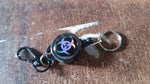 Retractable key chain attached to a belt, ideal for travel and office use.