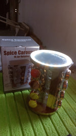 Golden LED spice organizer with 16 jars displayed on a kitchen shelf.