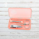 AuriGlam portable nail clipper set in its clear plastic travel case.