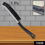 Ergonomic handheld Crevice Cleaning Brush tackling kitchen tile gaps.
